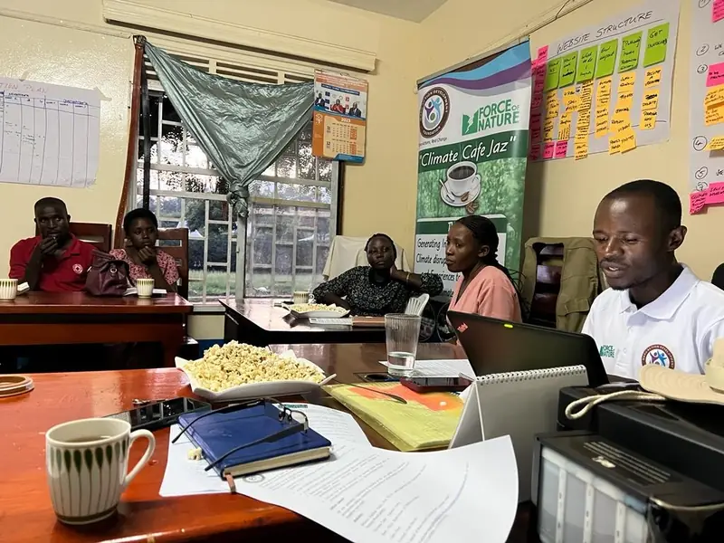 Participants seated around a table during a Climate Café discussion in the office